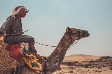 Arab man traveling on a camel