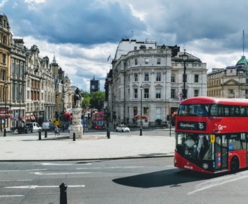 panoramic view of central london with a red bus passing