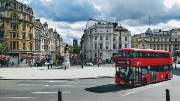 panoramic view of central london with a red bus passing